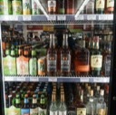 Cold box in a store, with the placed rye whiskey on the middle shelf.
